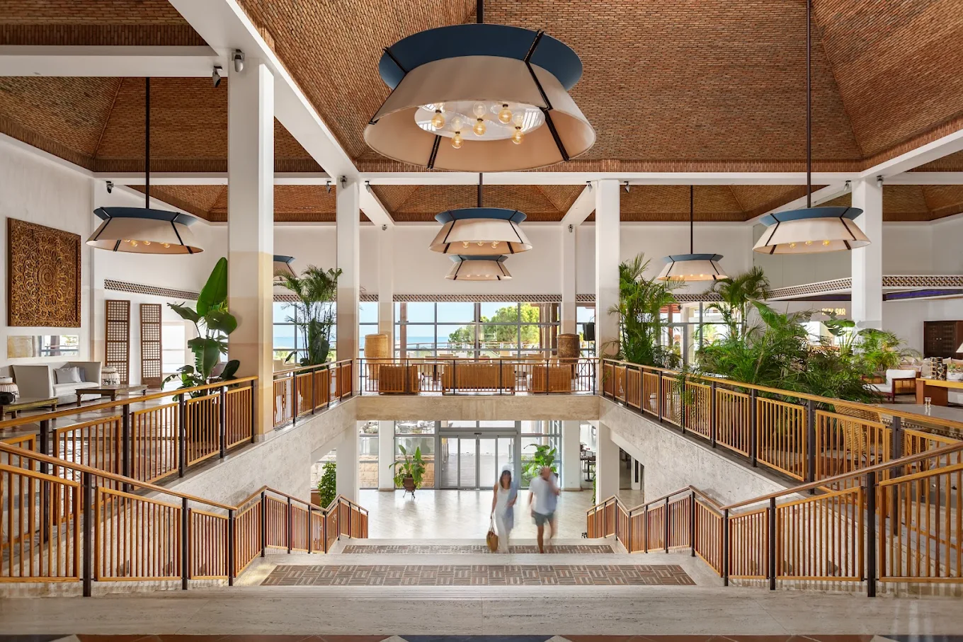Grande Real Santa Eulália Resort lobby with warm wood details and white columns
